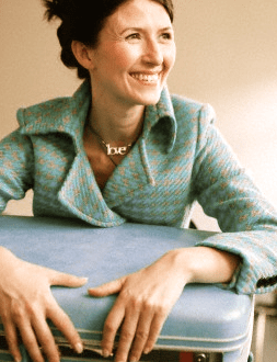 Woman with blue suitcase1 The Romance of Traveling Alone - EAT LOVE SAVOR International Luxury Lifestyle Magazine