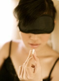 woman taking sleeping pill on jet Luxury Travel: Jet Lag Solutions - EAT LOVE SAVOR International Luxury Lifestyle Magazine