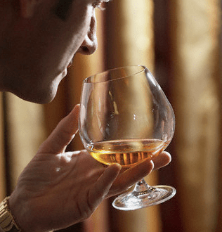 man and snifter Cognac: The History and the Art of Enjoying Cognac - EAT LOVE SAVOR International Luxury Lifestyle Magazine